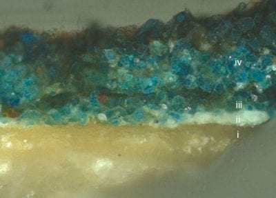 Fig. 30 Cross-section of sample RMA-AW-162/1 (marked with an arrow in fig. 1) taken from a dark fold in the Virgin Mary’s cloak showing: i) the chalk/glue ground, ii) a locally-applied lead white underlayer containing some black particles (up to 10 µ), iii) one or two layers of azurite containing some particles of red lake (10–20 µ), iv) a coarser layer of azurite (100–120 µ). Sample taken and photographed at a magnification of 200x by Arie Wallert.